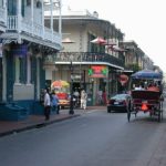 Bourbon Street with buildings on side and horse & buggy