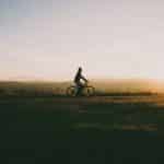 Person riding bike at sunset