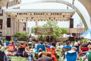 People sitting in chairs listening to blues concert