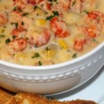 Corn and crawfish soup in white bowl