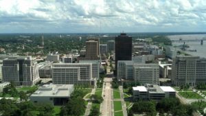 downtown baton rouge with buildings against cloudy sky