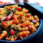 Shrimp and sausage with rice in blue bowl