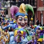 Mardi Gras Float of a large mask with purple green and gold
