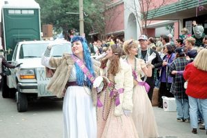 Two ladies dressed in costume walking in the Spanish Town Mardi Gras Parade