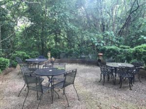 Back patio at The Stockade with wrought-iron tables and chairs