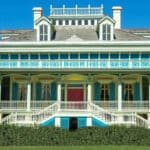 White and Blue plantation home set against blue sky