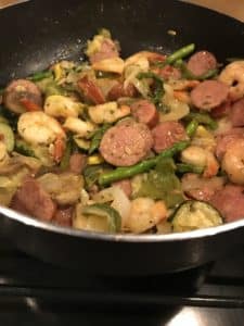 Sausage, shrimp, asparagus in black skillet