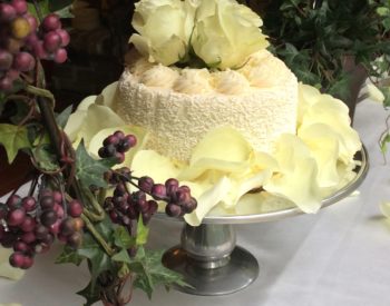 Wedding cake surrounded by greenery